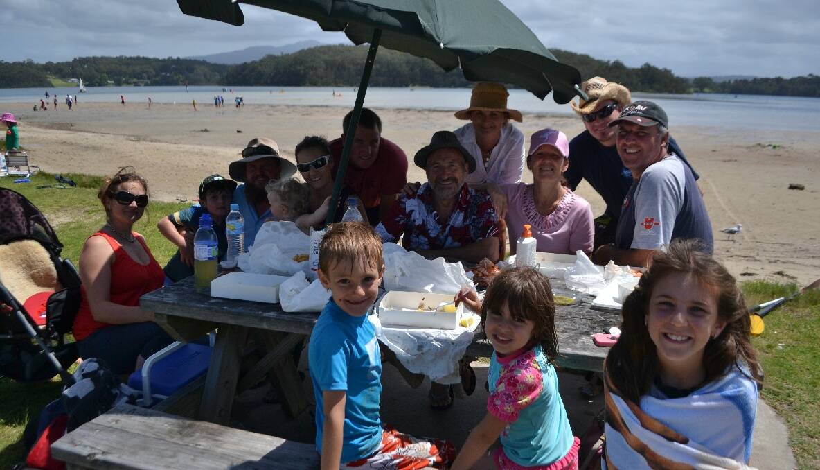 HOLIDAY TIME: Enjoying a holiday picnic and seafood from The Inlet at Riverside Park is Narooma resident Giovanni Carrus with all his family that came down from the Gold Coast and Sydney. 