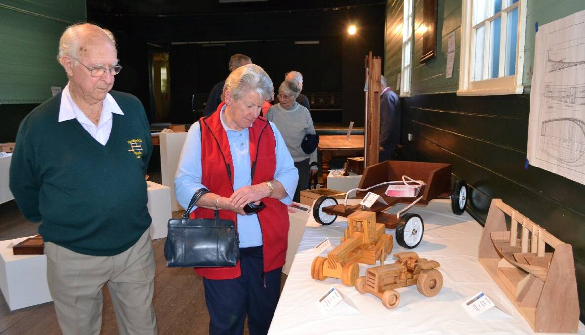WOODEN TOYS: Admiring the wooden toys at the Woodies exhibition are Les Low of the Eurobodalla Woodies and his friend Margaret Jonas, both of Batemans Bay. 