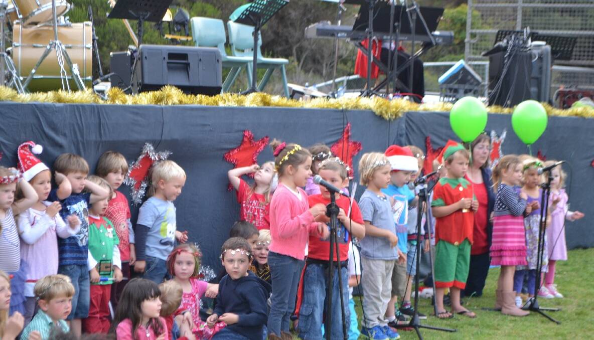 KINDY SINGERS: The Narooma Kindergarten singers perform in front of the stage at the Narooma carols. 