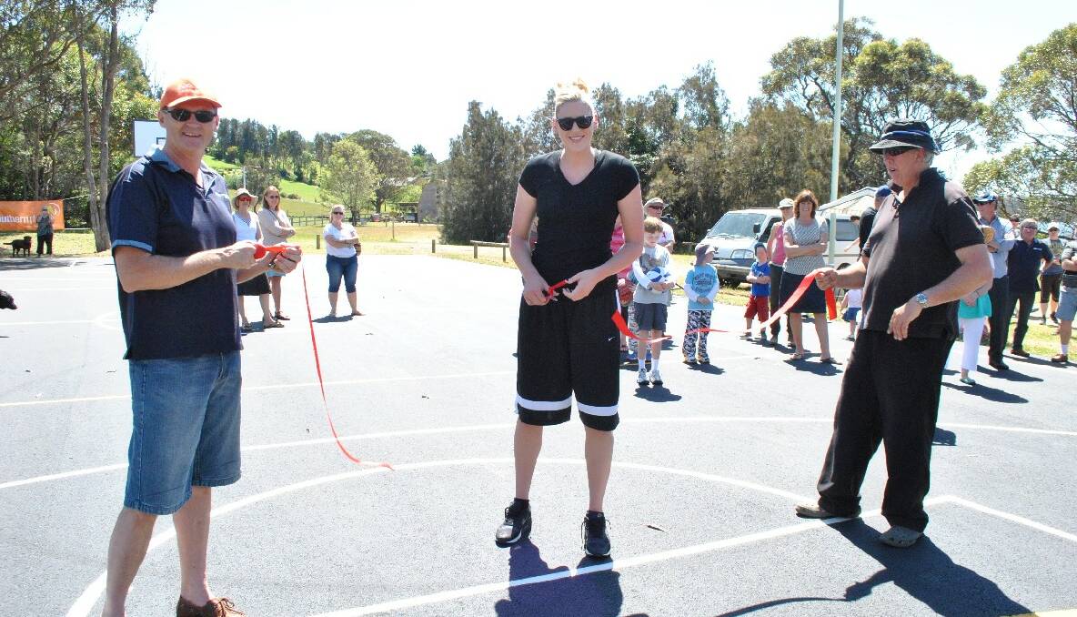 OFFICIAL OPENING: World champion basketball player Lauren Jackson cuts the ribbon declaring the new basketball court open while Eurobodalla Shire Council mayor Lindsay Brown holds one end of the ribbon and Tuross Head Progress Association president Lei Parker holds the other end. 
