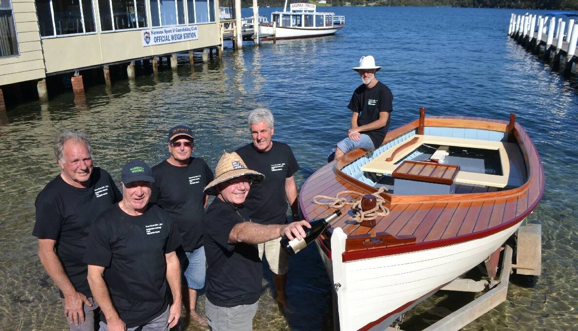 ONTO WAGONGA: Narooma Centre for Wooden Boats members Jimmy Taylor, Brian Craven, Mark Westwood, Tim Short, Peter Nicholson and Smilie Magill launch their first boat on Friday. Absent was Peter Lonergan. 