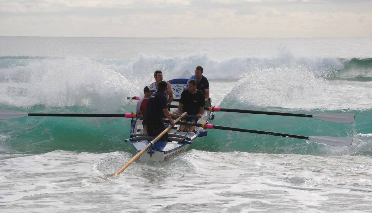 TRAINING: The Narooma George Bass Surfboat Marathon crew training off Narooma’s main surf beach. Photo by Fleur Constable