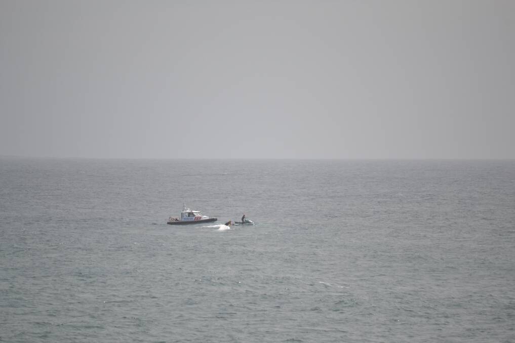 LOCATED: Marine Rescue identifies the upturned boat off Dalmeny on Sunday. 