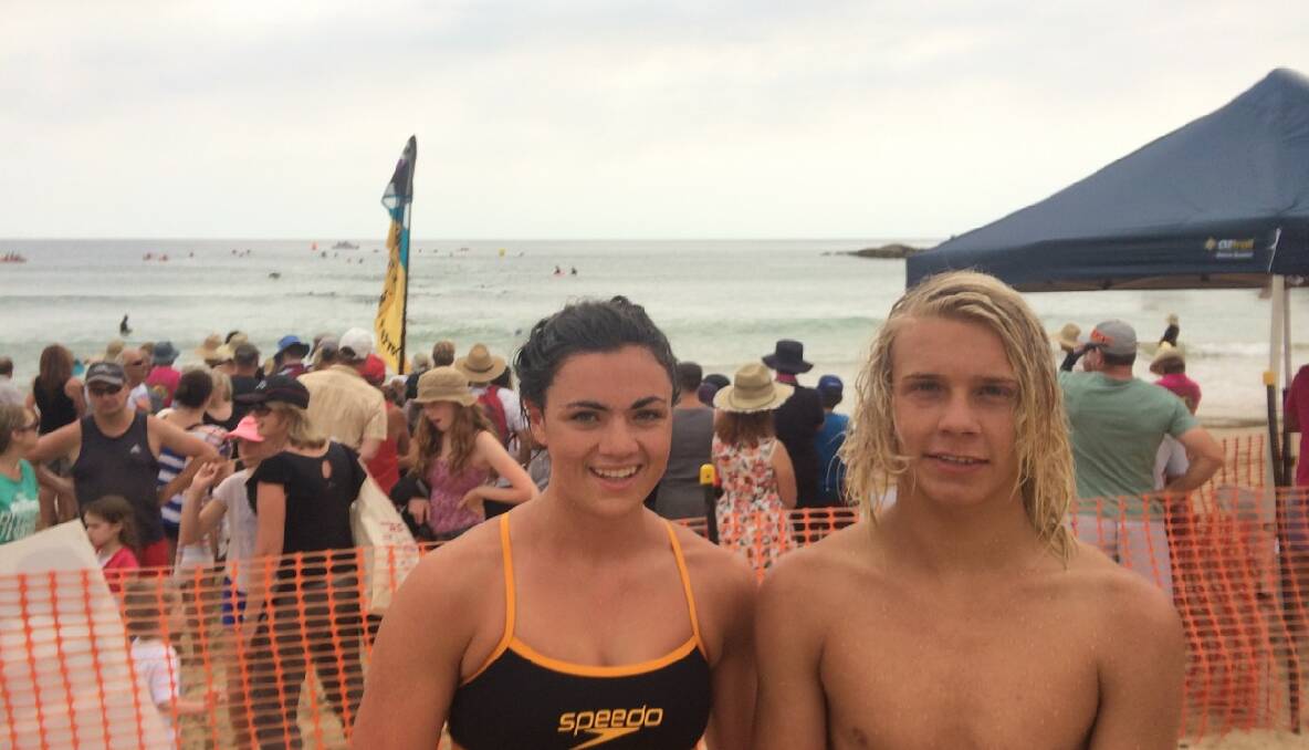 FIRST PLACES: Millie Boyle of Cobargo and the Bermagui Surf Life Saving Club and Clifford Taylor of Narooma finish the Tathra Wharf to Waves first in their age division of 14 to 17 600m swim. 