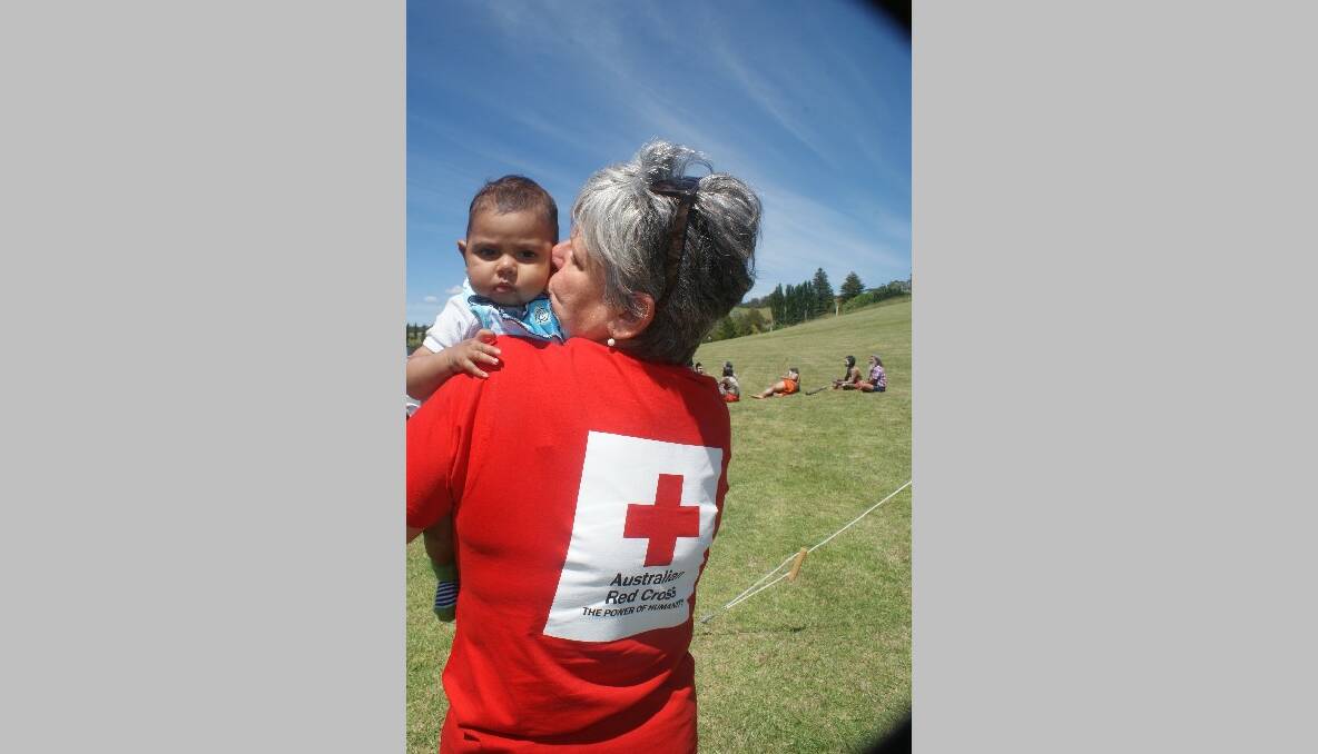 RED CROSS: Shanna Provost from Red Cross with a young one at the Yuin celebration on Saturday.