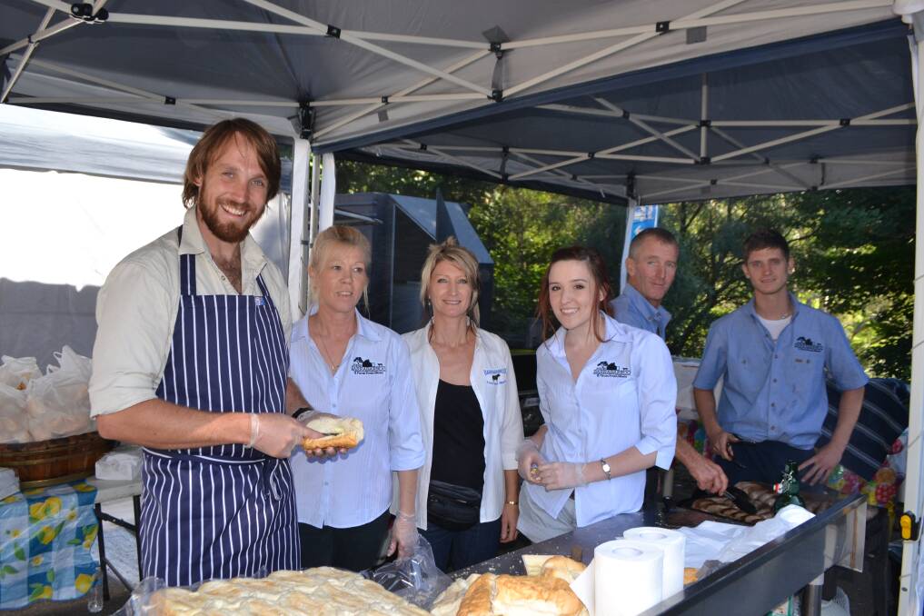 AT THE FAIR: Paul put in an appearance at the Tilba Easter Festival helping out on the stall of local sausage producer.