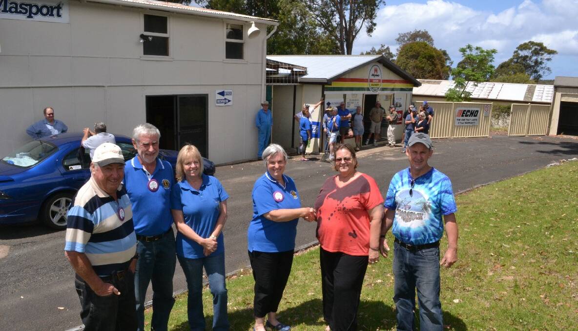 NEW HOME: Narooma Lions Club Men’s Shed committee members John Glover, Rob Atkinson and June Sheard and Lions Club president Adrianne Waterman at the hand over with owners Kris and Colin Macauley of Dalmeny.  