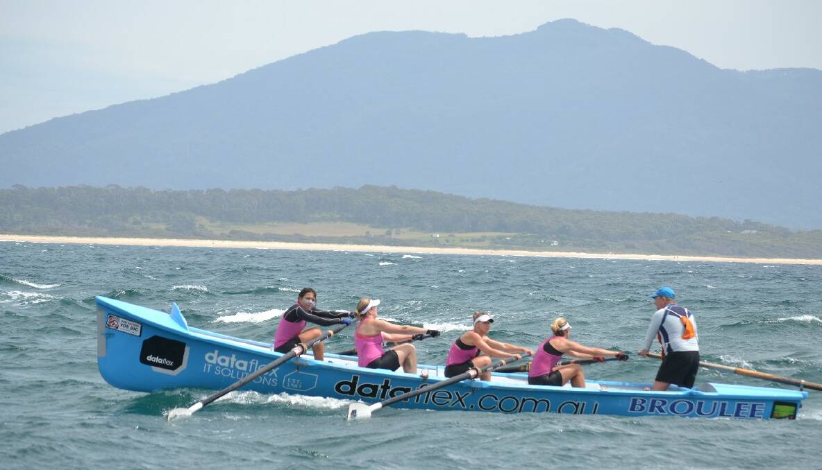 The Broulee Capital women row to the finish at Bermagui in Day 4 of the 2013/2014 George Bass Surfboat Marathon.
