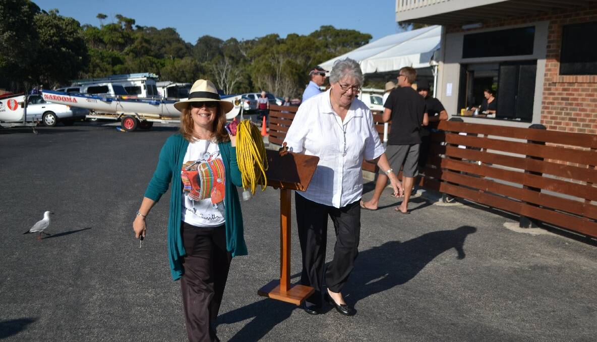 CHOIR CREW: Melinda Antill and Carol Holland from the Narooma Community Choir help set up for their performance at the Narooma Australia Day ceremony. 