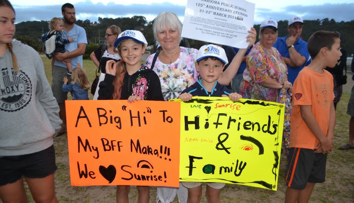 LOCAL KIDS: Local Narooma kids Piper and Noah Smith with Sylvia Gauslaa, who had her own sign promoting the upcoming 125th anniversary reunion of the Narooma Public School.