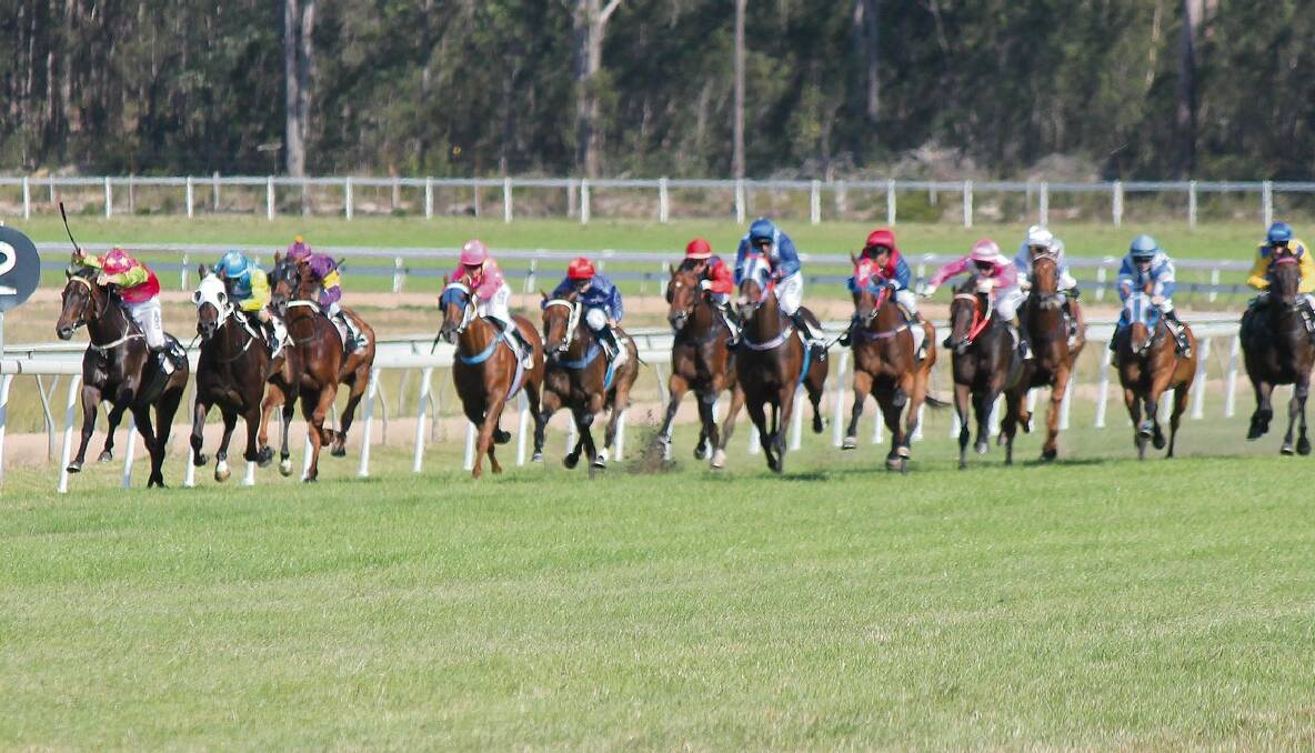 BEGA: Jason Devrimol riding Laurie’s Legend (left) dives over the line just half a length in front of second-place getter Koby Jennings on Al Ahmar during the Bega Cheese Bega Cup on Sunday.