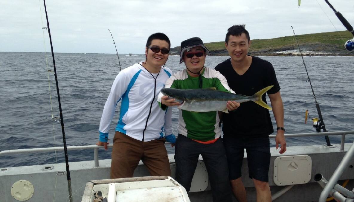SHERIFF KING: Ralph Yam with his kingfish and friends on board The Sheriff at Montague Island on Sunday. 