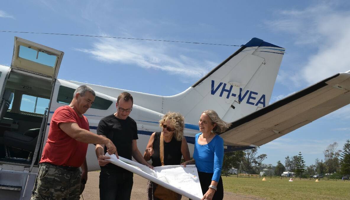 FOREST FLIGHT: Local conservationists Keith Hughes and Harriet Swift discuss the flight observations with Greens MP David Shoebridge and Greens Senator for NSW Lee Rhiannon at Moruya airport. 