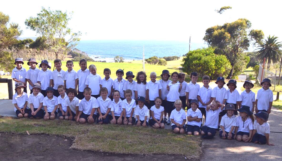 NEW YEAR: All the Year 1 students line up at Narooma Public School with the great backdrop of the ocean behind them. 