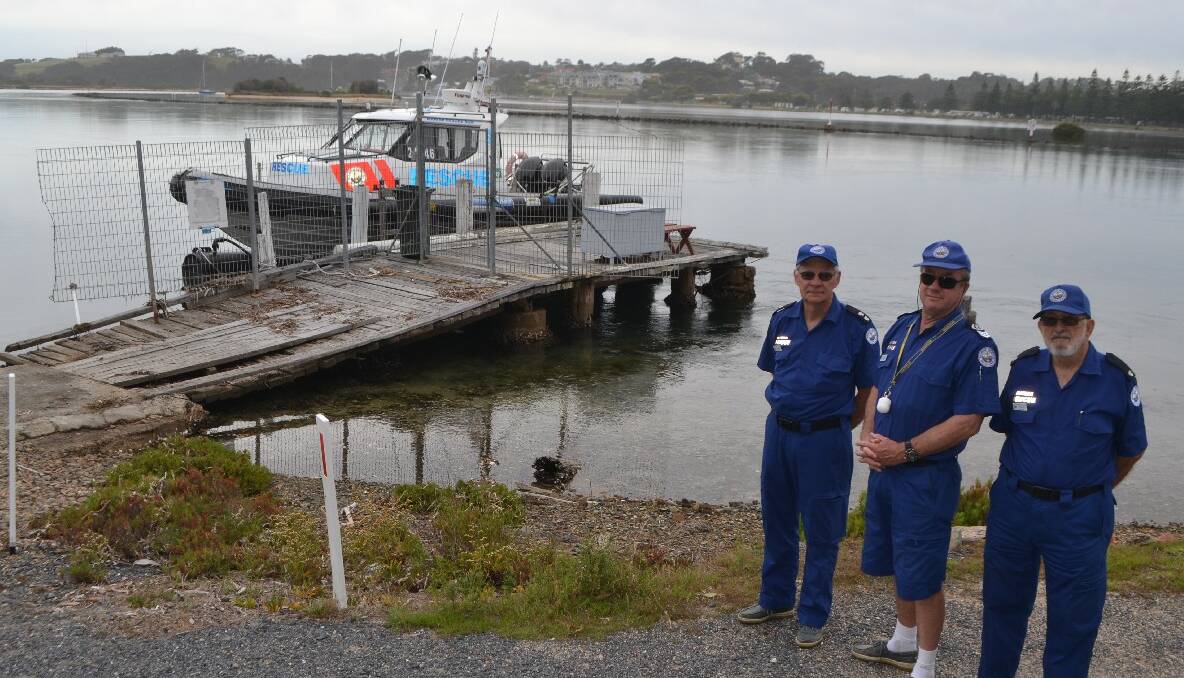 OLD PONTOON: Acting Narooma unit commander Eric Hibbett, senior skipper Ross Constable and volunteer Stan Swarbrick at the old falling down pontoon at Mill Bay.  