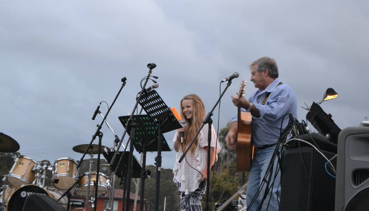 CHARLIZE SINGS: Keeping up the family tradition of singing at the carols is Charlize Butcher on stage with Graham Osborne. Her sister Tayla also performed. 