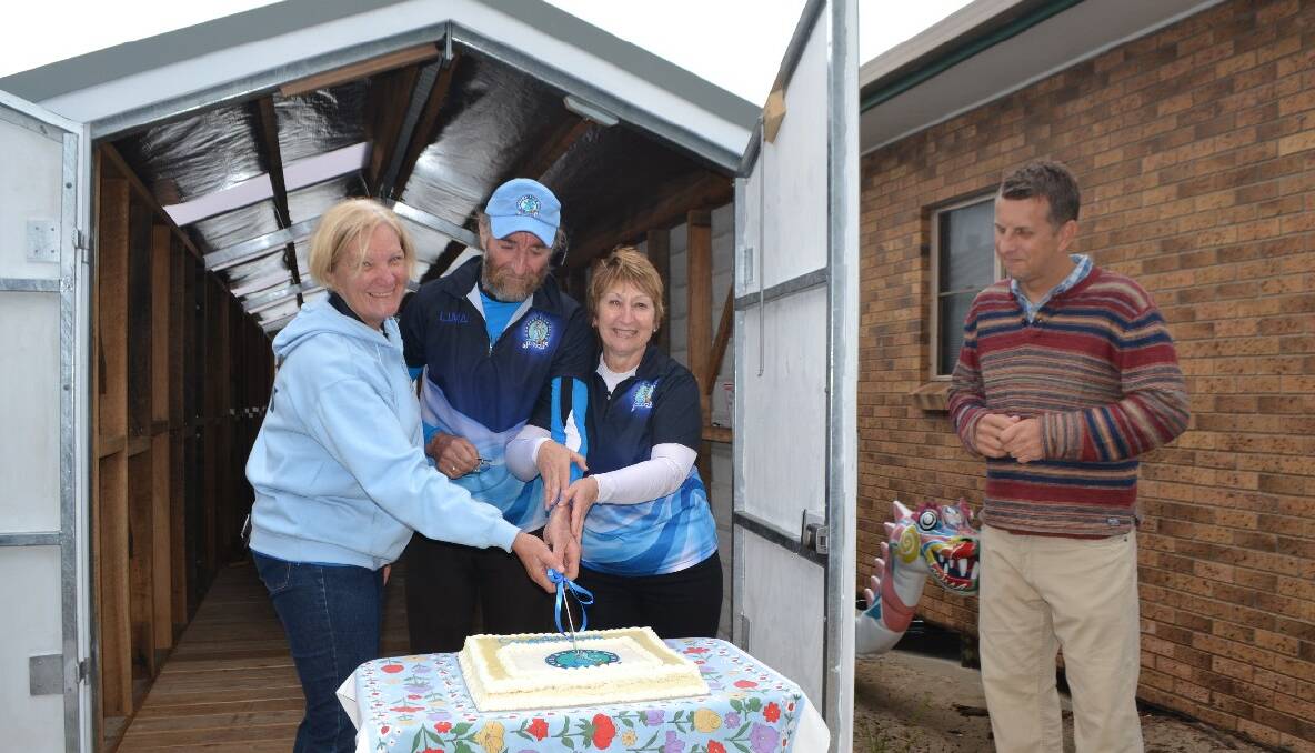 FOUNDING MEMBERS: The Narooma Blue Water Dragons founding members Kathryn and Peter Essex and Alexis Swadling cut the cake watched by State Member Andrew Constance. 