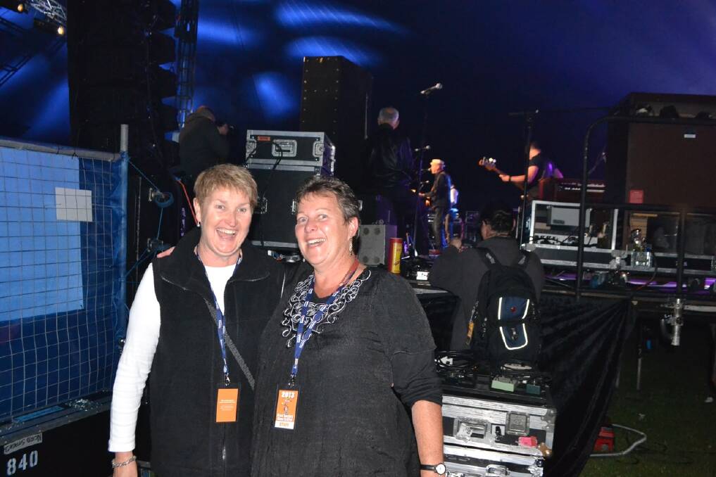 RELAXING: Narooma Locals Suzie Egan and Cathy Cropper relax backstage while Russell Morris plays on Sunday evening after a busy weekend selling merchandise.