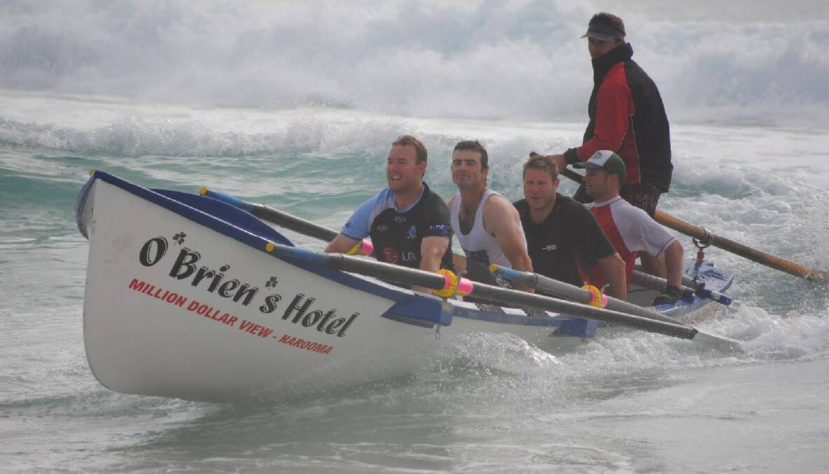 WAVE RIDERS: The Narooma Surf Life Saving Club rowers ride a wave back in after another grueling training run earlier this month. Pictured are Adam Morris, Rod Patmore, Johnny Davis, Jae Constable and sweep Brendan Constable. Photo by Fleur Constable 