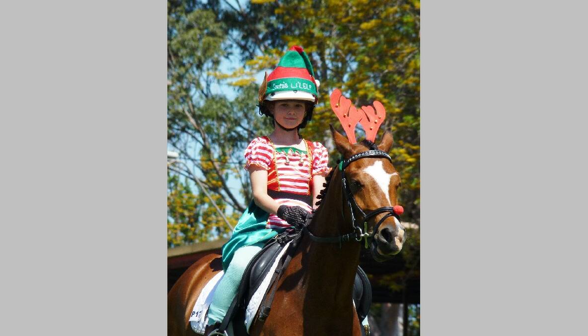 Paige Moxey (Santa's Little Elf) with her reindeer Brampton Halloween dressed for their Christmas Freestyle routine.