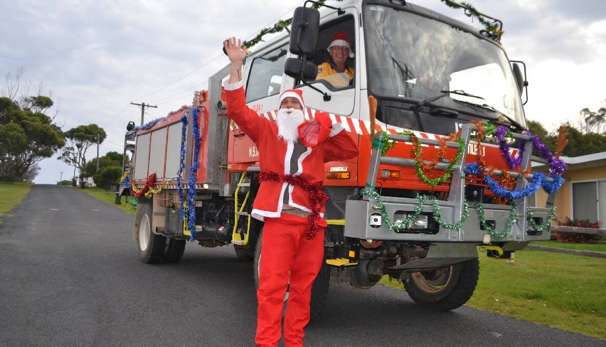 SANTA PAUL: River Cottage Australia host Paul West is the latest member of the Tilba RFS brigade and played Santa on Sunday evening while Harry Bate drove the fire engine. 