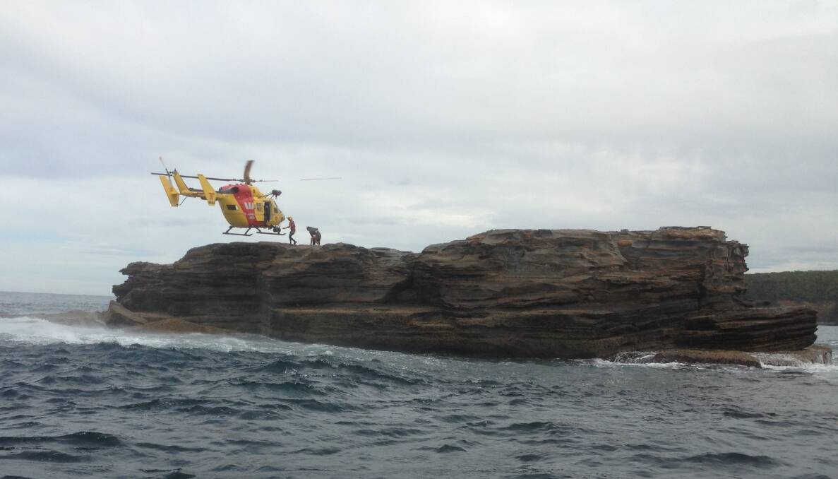 RESCUE CHOPPER: The Westpac Lifesaver 3 chopper hovers to retrieve the couple. Photo credit Batemans Bay SLSC