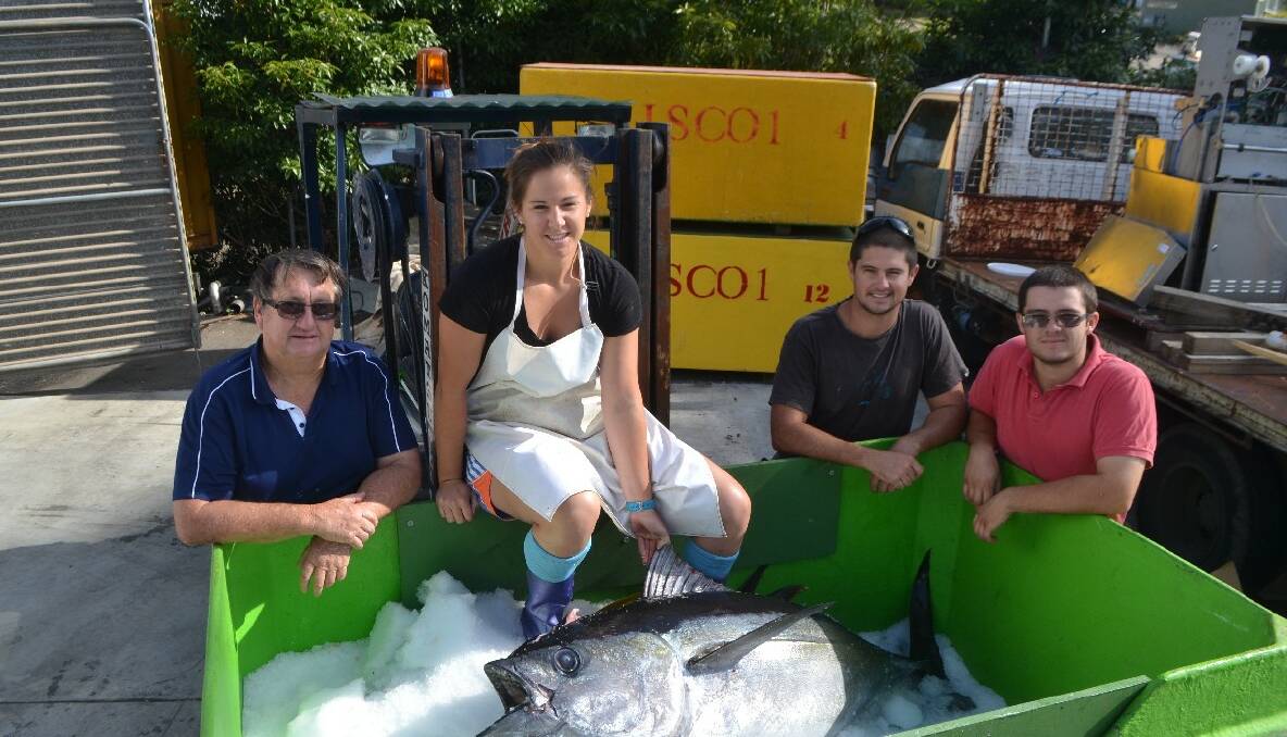 CATCH OF DAY: John, Hayley, Todd and Ryan Abbott with a nice 70kg bigeye tuna processed at their factory on Friday morning to be offered for sale in portions at a Canberra farmers market the next morning. 