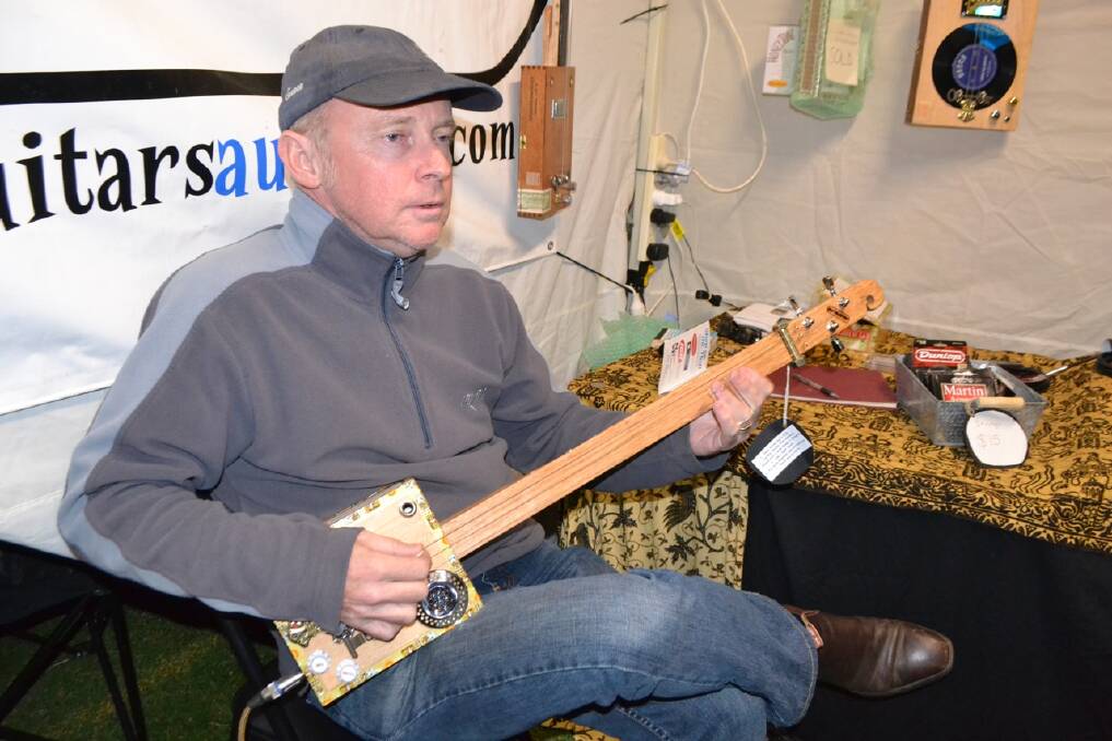 MCTRUSTRY GUITARS: Selling his handmade cigar box guitars at the Narooma Blues Fest was Nigel McTrustry from Brisbaine.