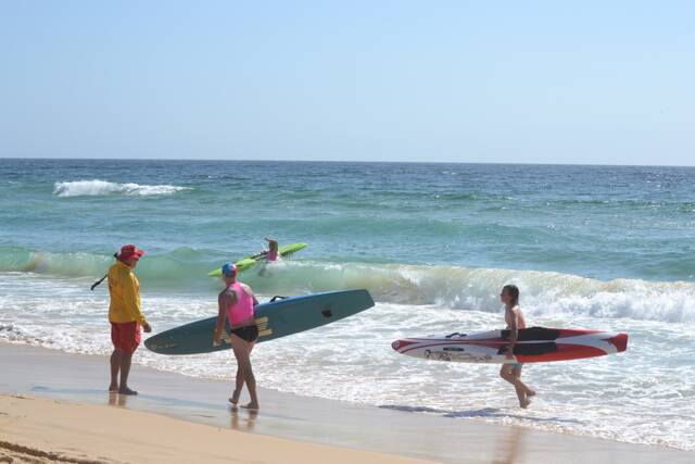WATER CLEARED: Narooma SLSC patrol captain Roger Adams helps clear the water after the shark alarm. 
