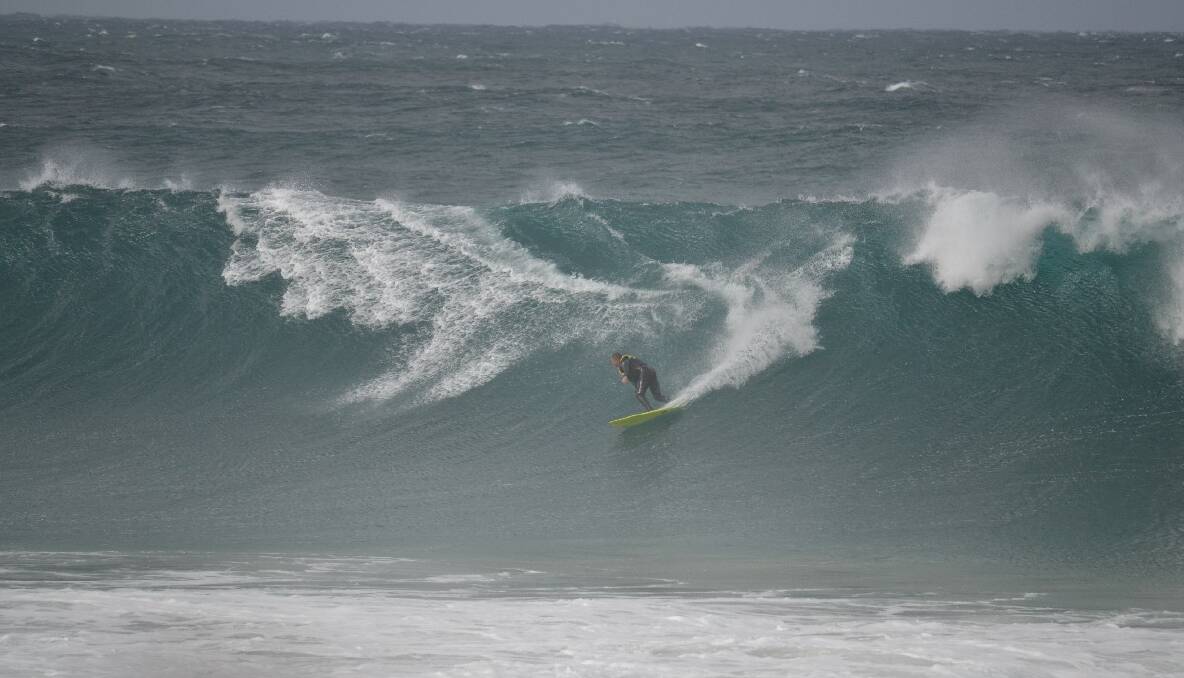 TOW-IN TIME: Local big-wave experts Tony Lawson and Morgan Evans tow-in surf the Narooma bar on Friday. 