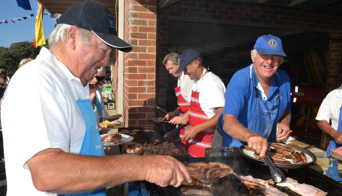 BARBIE CREW: Working hard and building up a sweat on the Australia Day barbecue are Brendan Constable and Pete from the surf club and George Hogg and John Glover from the Narooma Lions Club. 