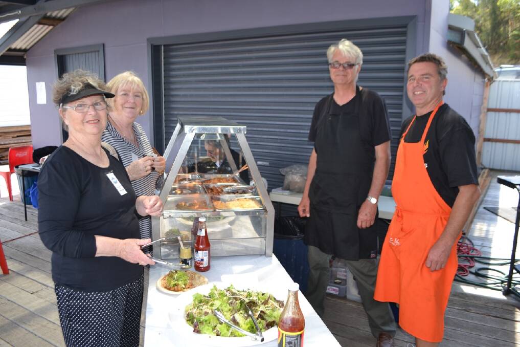 CATERERS: Caterers Garry Ebbeling and Dave Moore serve Heather McIldowney and Janice O’Shea from Melbourne and Sydney respectively and who came to sail on board Thumper. 