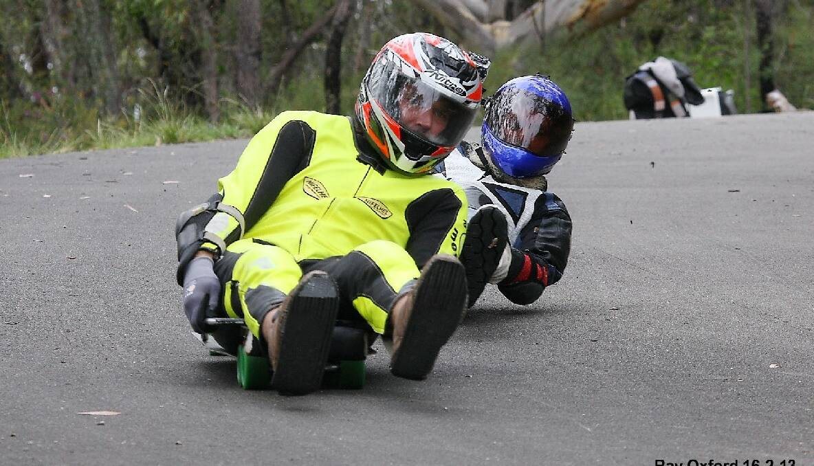DOWNHILL DUDES: Chris Markwort and Ken Jacobs both from the Bermagui area compete in the recent Launch street luge event in the Blue Mountains. Photo by Ray Oxford  