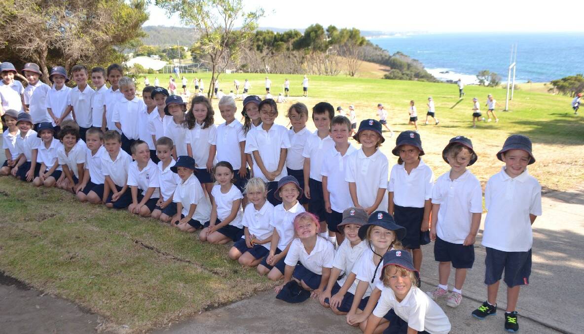 FIRST YEAR: The Year 1 group at Narooma Public School on their second day at school with the Year 5s exercising in the background. 