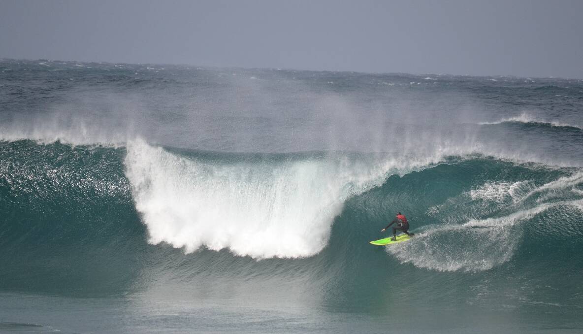 TOW-IN TIME: Local big-wave experts Tony Lawson and Morgan Evans tow-in surf the Narooma bar on Friday. 