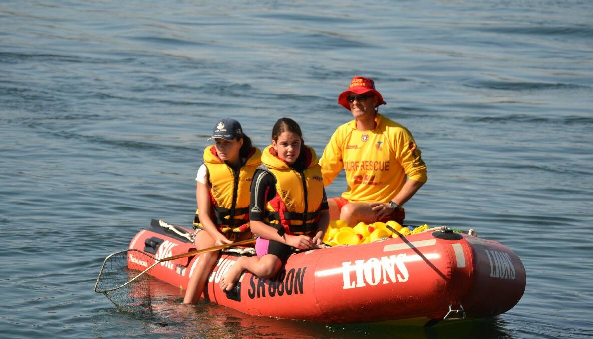 DUCK COLLECTORS: Libby, Sam and Ben Bate from Narooma Surf Life Saving Club helped collect the ducks after the Rotary Australia Day duck race. 