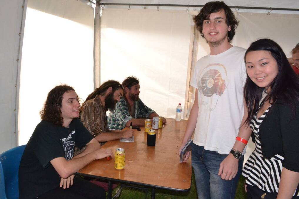 SIGNING TENT: Fans from Goulburn Tina Chung and Royce Davies get their “merch” signed by the Two River Blues band.