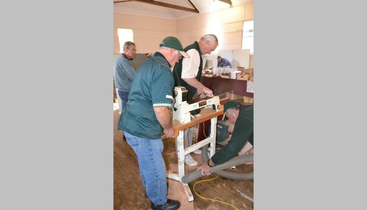 LATHE DISMATLE: Dismantling one of the lathes after the show are Eurobodalla Woodies members Peter Brotherton of Catalina, Malcolm McDonald of South Durras and Cyril Elliott of Broulee. 