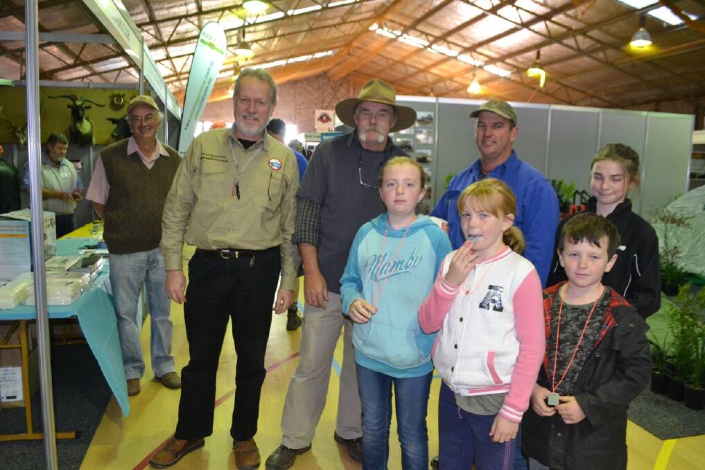 FEST ENTRANCE: Shooters and Fishers Party MP Robert Borsak and South Coast Hunters Club president Dan Field greet Cobargo family, dad Matt Evans and kids Marcy, Ashley, Brett and Ellen.