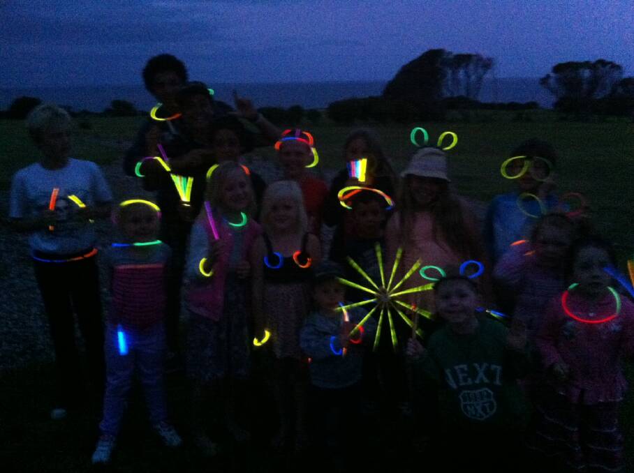 GLOW KIDS: Wearing their glow sticks the Narooma New Year’s Eve fireworks at the Narooma Golf Club are the kids from the Gelling family party from the Central Coast, 40 of whom packed out the Mystery Bay campground. Photo by Stan Gorton 