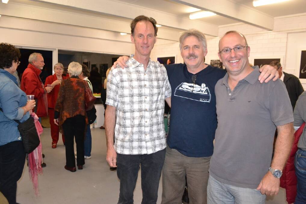 PRE-FESTIVAL SHOW: Narooma photographer and artist Tim Burke launched his show at the Narooma SoArt gallery and is pictured with musician mate Chris O'Conner and Nigel Jackson who helped set the music-themed show.