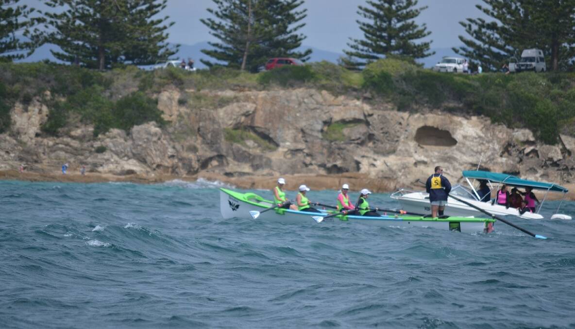 The Broulee Bats women  row to the finish at Bermagui in Day 4 of the 2013/2014 George Bass Surfboat Marathon.