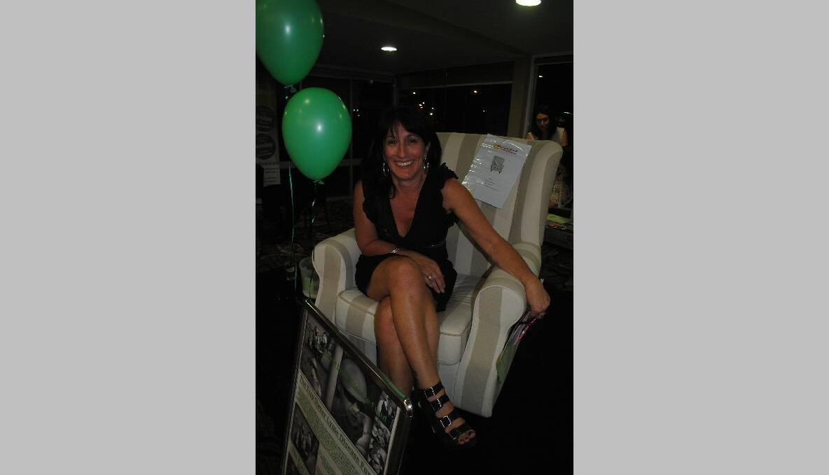 STEVER FUNDRAISER: Fran Held reclines in a beautiful arm chair - one of the auction items at Club Narooma on Friday night.