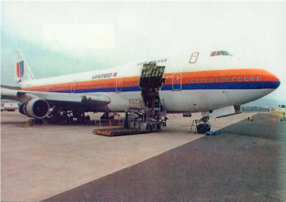 ILL-FATED JUMBO: The United Airlines 747 on the tarmac at Hawaii showing the massive hole where cargo door ripped open.
