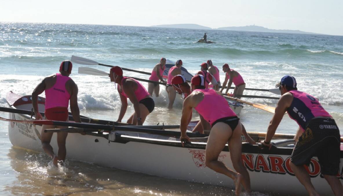 SURF ACTION: The two Narooma SLSC surfboat teams in action on the beach during the carnival