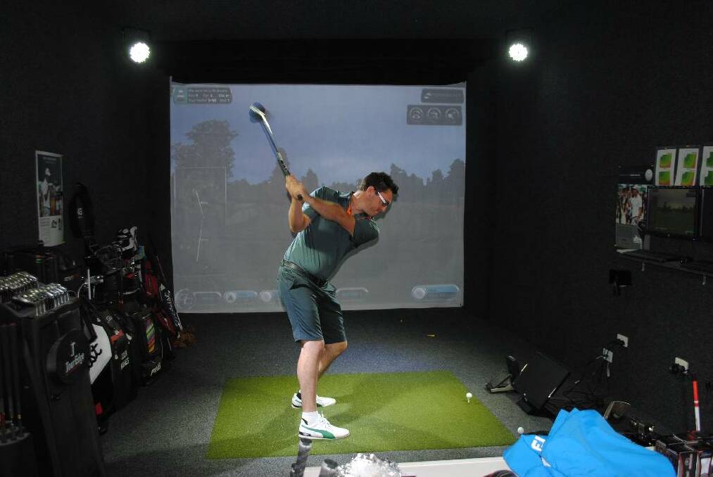 SWINGER: Josh Dielman takes a swing in the new Technology Centre at Narooma Golf Club that was installed by golf pro Colin Holmes.