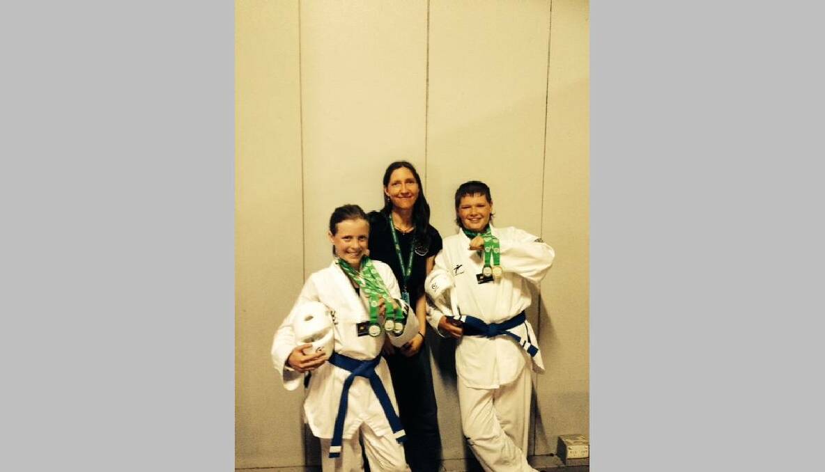 TILBA TAE KWON DO: Pictured at Sydney Olympic Park showing the gold and silver are Tilba Tae Kwon Do members Bethany Partridge with coach Zoe Cooper and Bradley O'Sullivan.