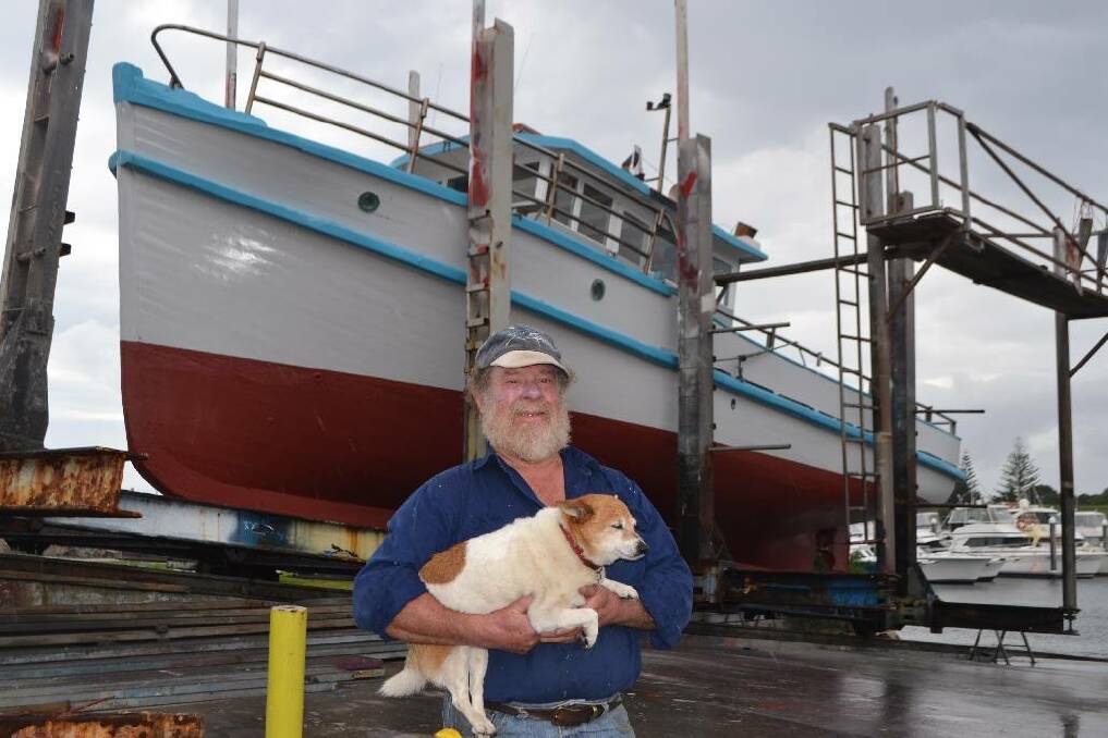LONG LIFE: Keith Appleby reckons his boat “Binjarra” has plenty of life left in her but is about to retire after 30 years in the business. Also in the picture is Barney the sea dog who loves going out on charters.