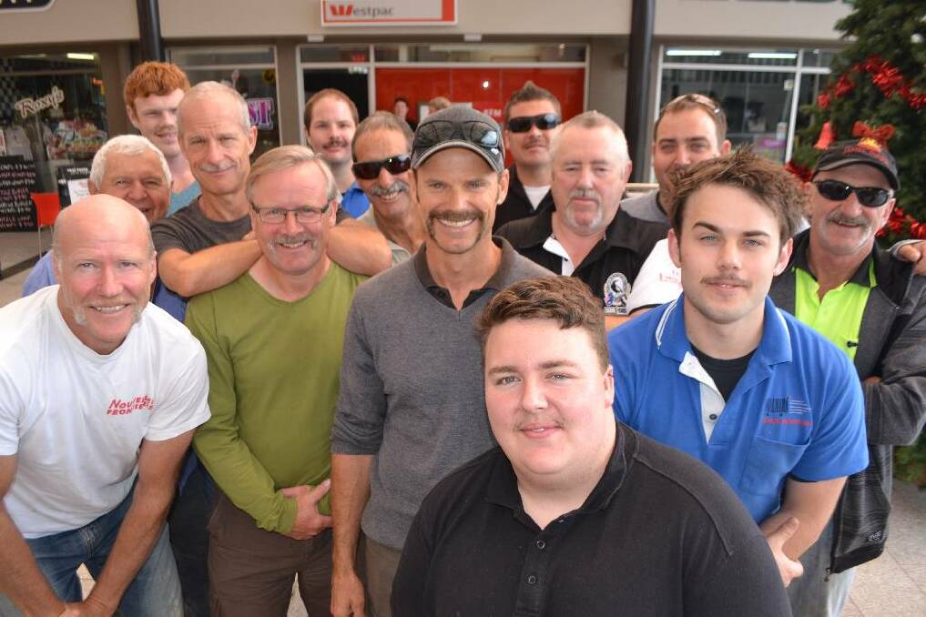 THE LADS: Team Narooma Plaza gather for a group shot under the dome. Mark Anderson (centre) was voted the best “mo” while Bill McLeod behind him and to the right was the runner up.