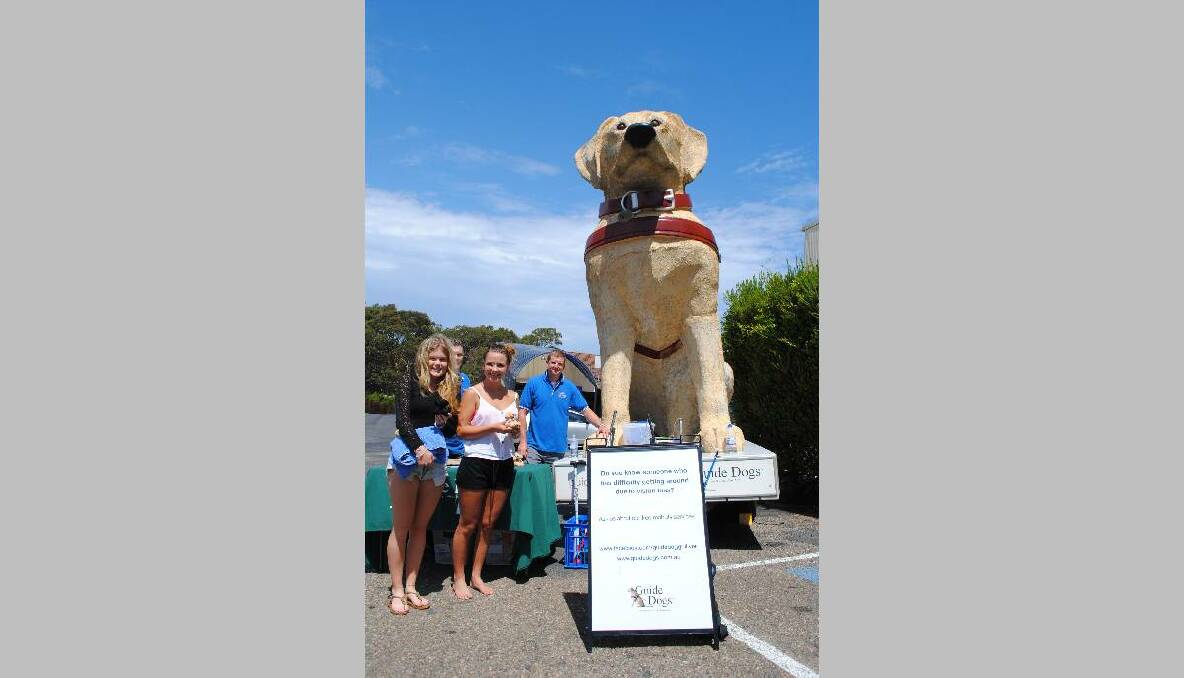 GULLIVER TRAVELLING: Emily Stokes and Ruby Roberts are introduced to Gulliver the giant guide dog at Narooma Plaza yesterday by Chace Richardson, an orientation and mobility instructor with Guide Dogs NSW/ACT.